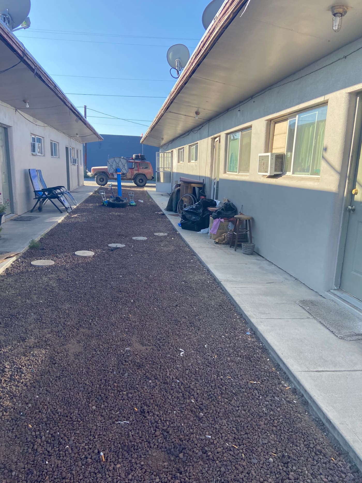 The 12-unit Moses Lake property before acquisition, with gravel walkways and aging exteriors