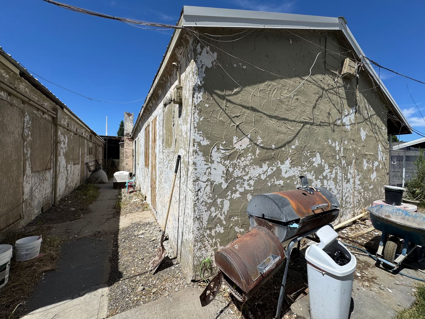 The Ephrata building before acquisition, with peeling paint and a vacant, deteriorated exterior